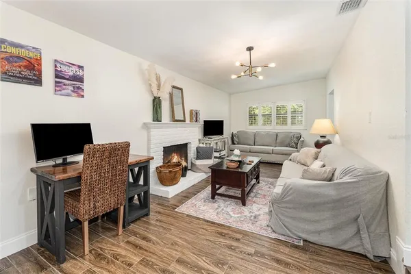 a living room with furniture fireplace and a table