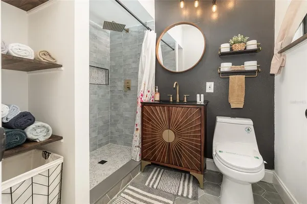 a bathroom with a sink a toilet and a mirror