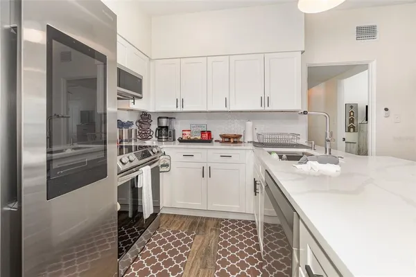 a kitchen with a sink stove and refrigerator