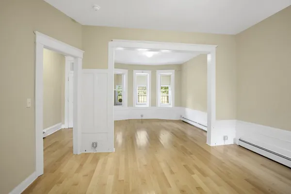 wooden floor in an empty room with a window