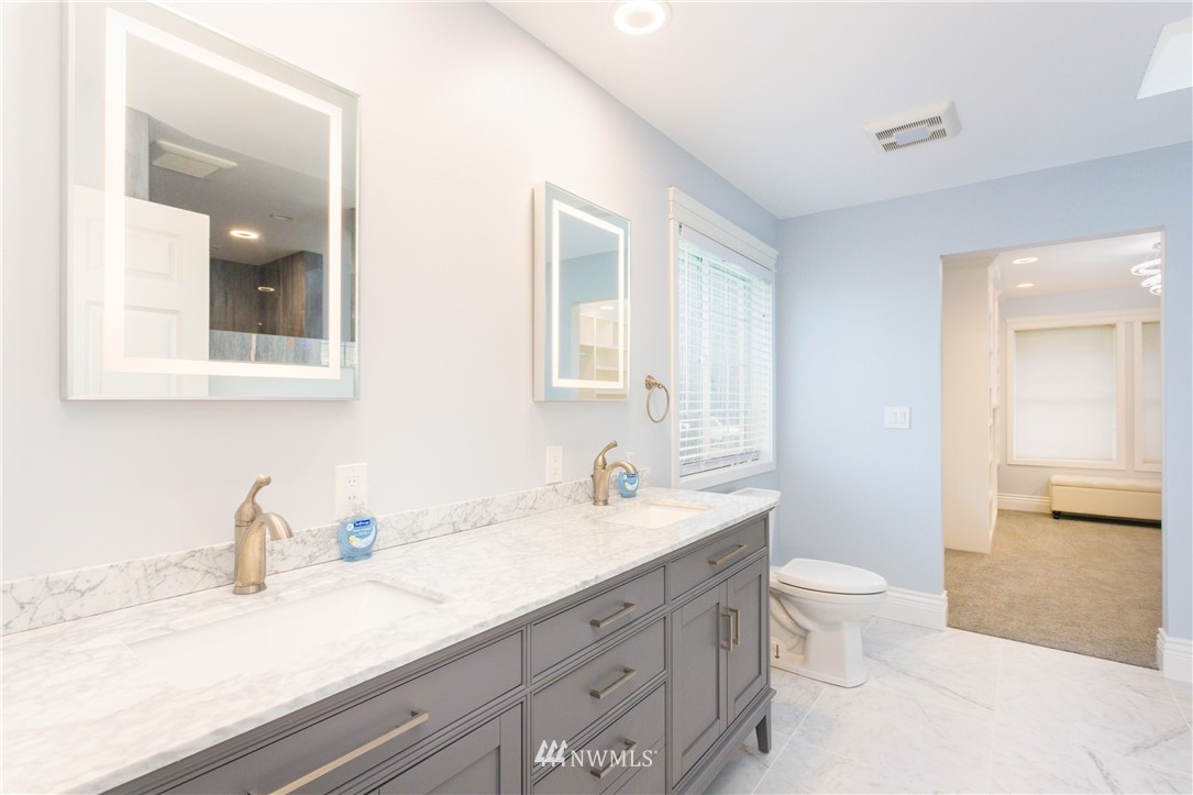 8416 Delta Line Road Custer, WA 98240 - Photo 12 of 40 a bathroom with a granite countertop sink mirror vanity and toilet
