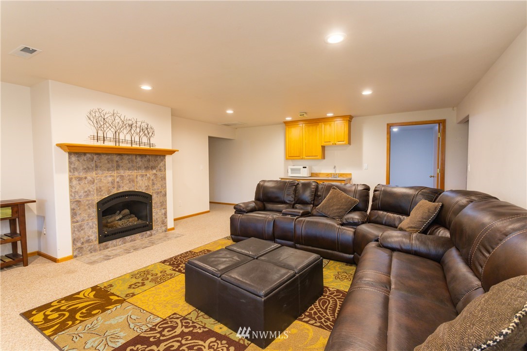8416 Delta Line Road Custer, WA 98240 - Photo 17 of 40 a living room with furniture and a fireplace