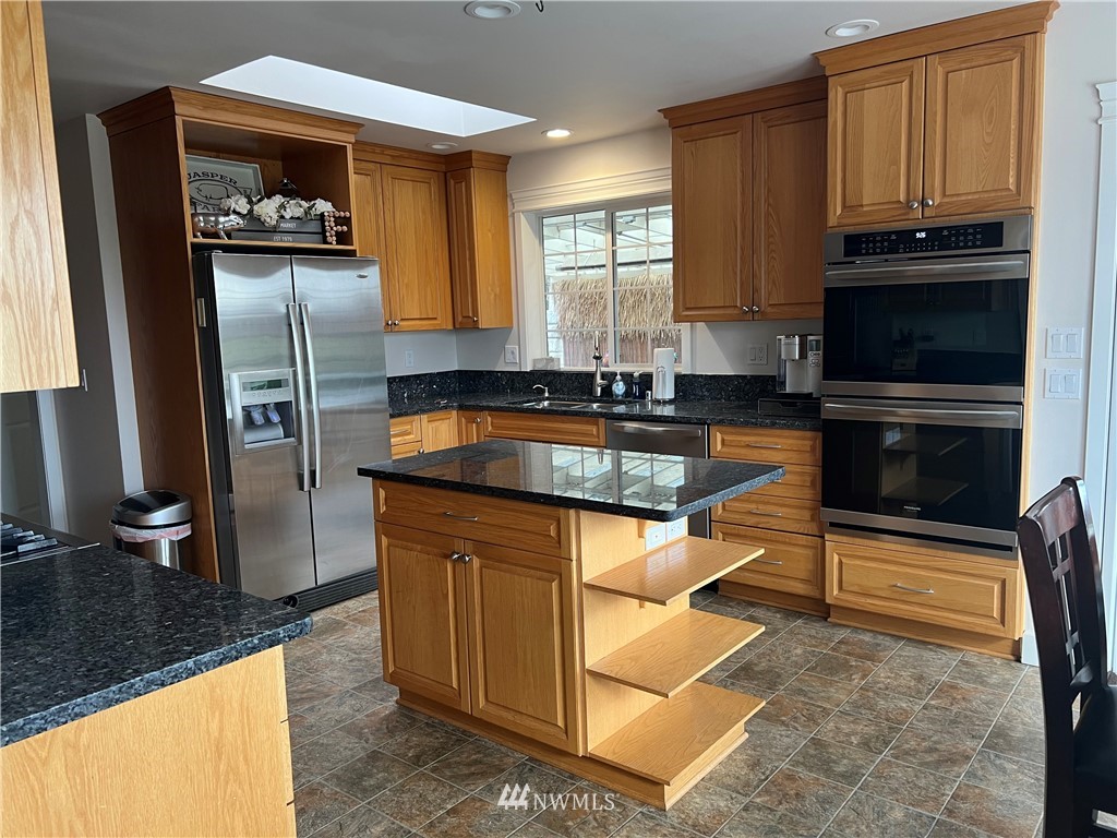 8416 Delta Line Road Custer, WA 98240 - Photo 9 of 40 a kitchen with granite countertop a refrigerator and a sink