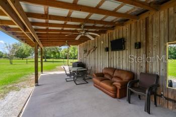 42415 Big Oak Road Altoona, FL 32702 - Photo 4 of 19 a view of a porch with furniture and garden