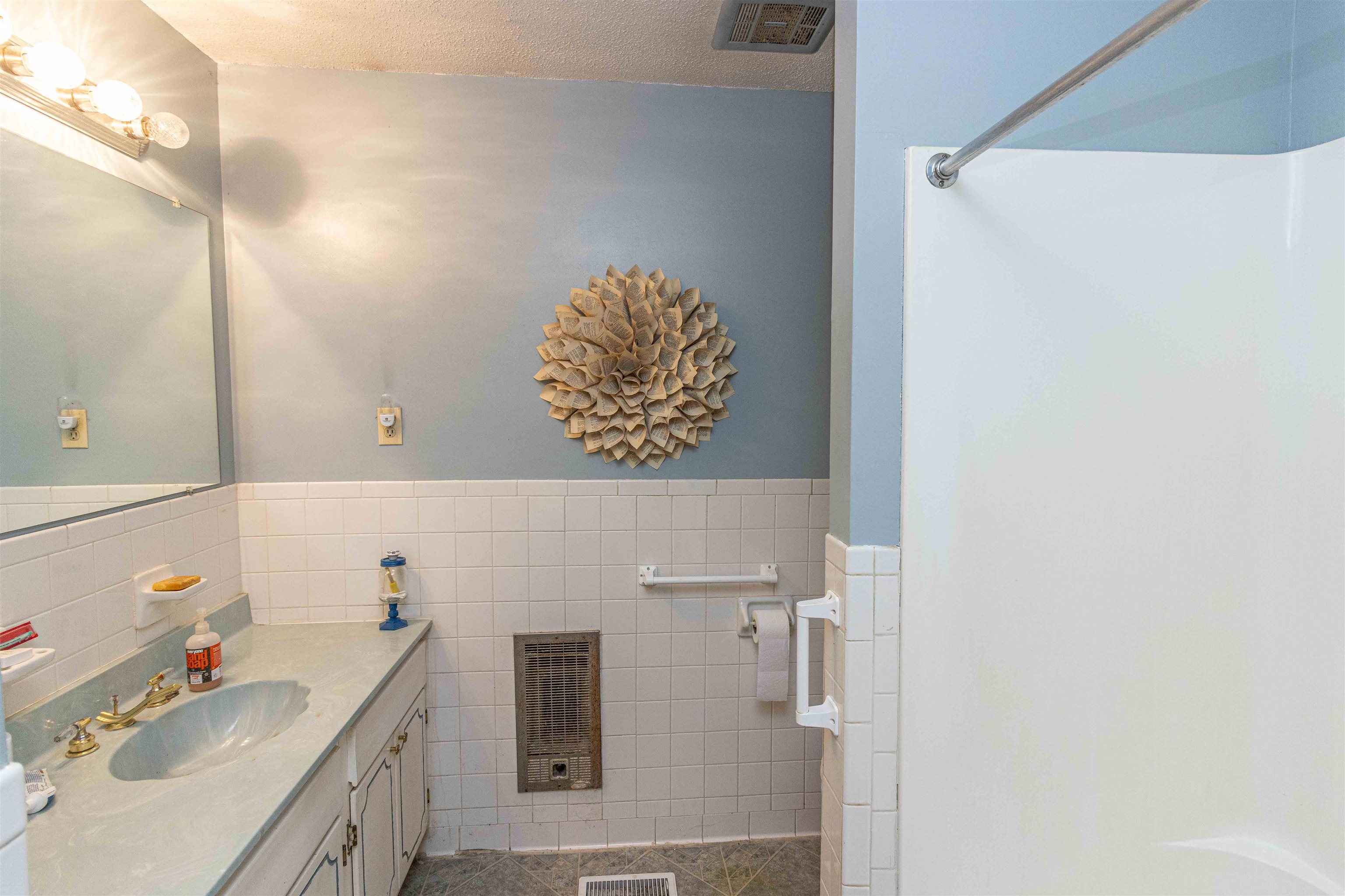 260 Mitchell Street Selmer, TN 38375 - Photo 13 of 22 a bathroom with a sink and a mirror