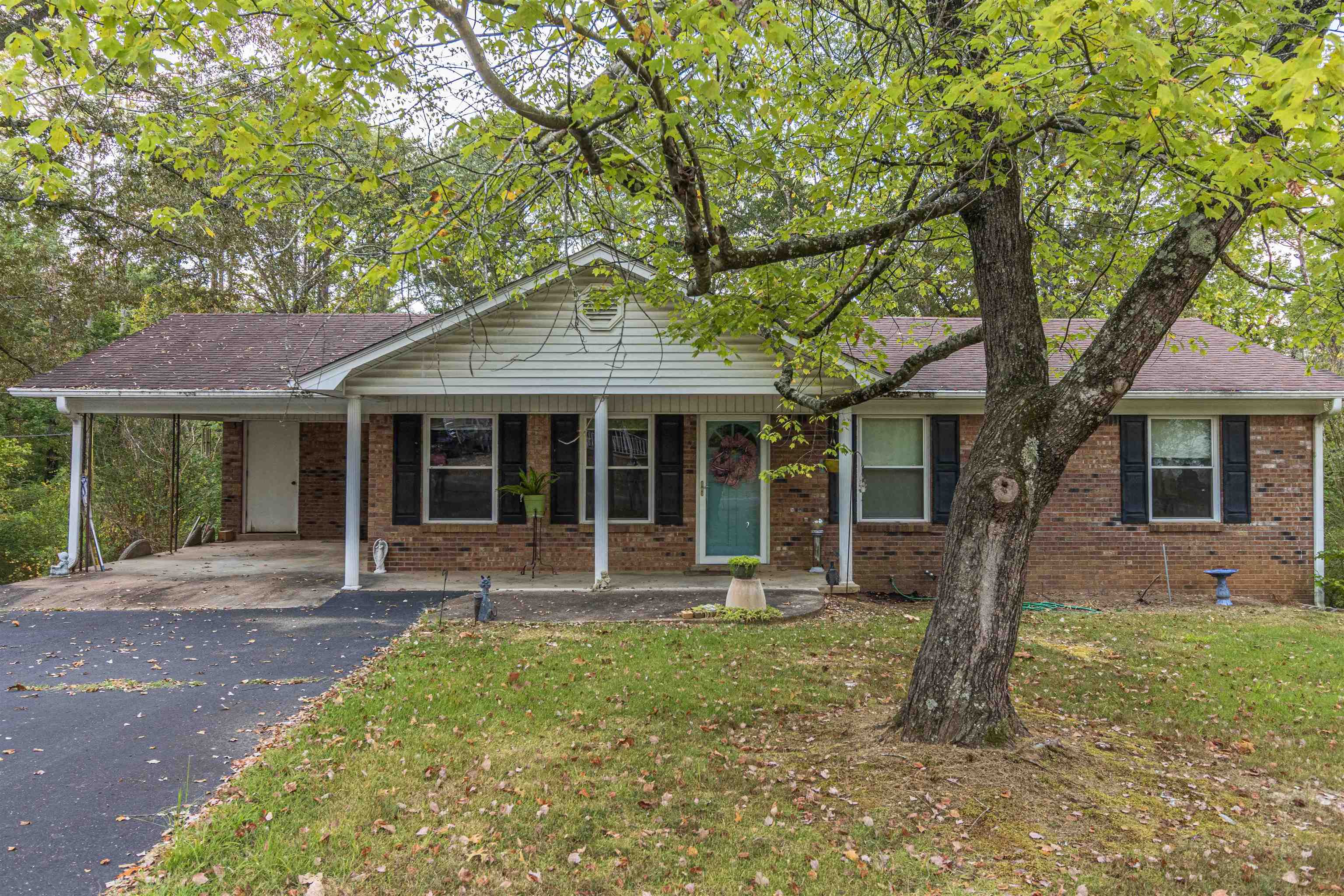 260 Mitchell Street Selmer, TN 38375 - Photo 2 of 22 a front view of a house with garden and porch