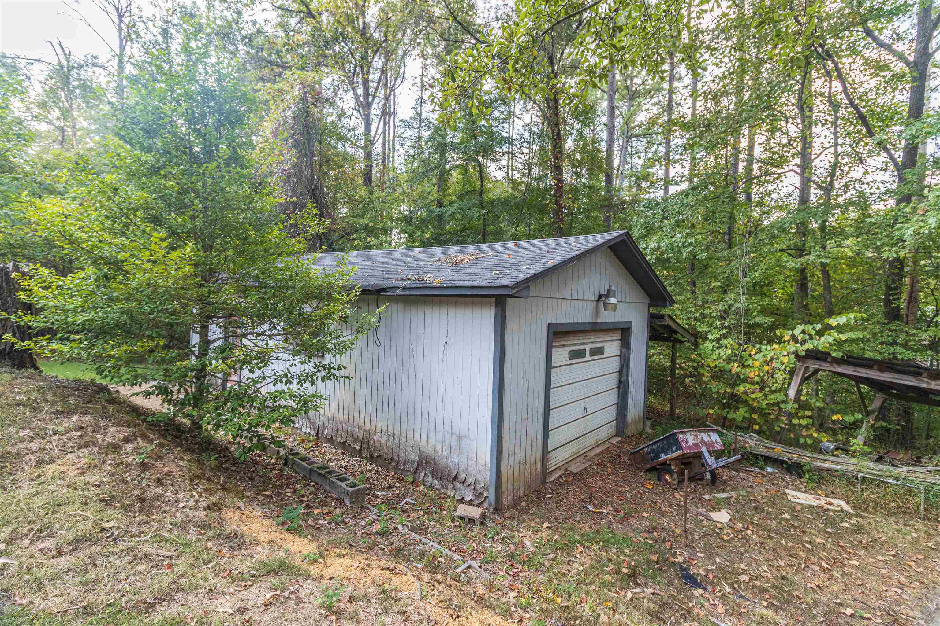 260 Mitchell Street Selmer, TN 38375 - Photo 21 of 22 a backyard of a house with large trees and wooden fence