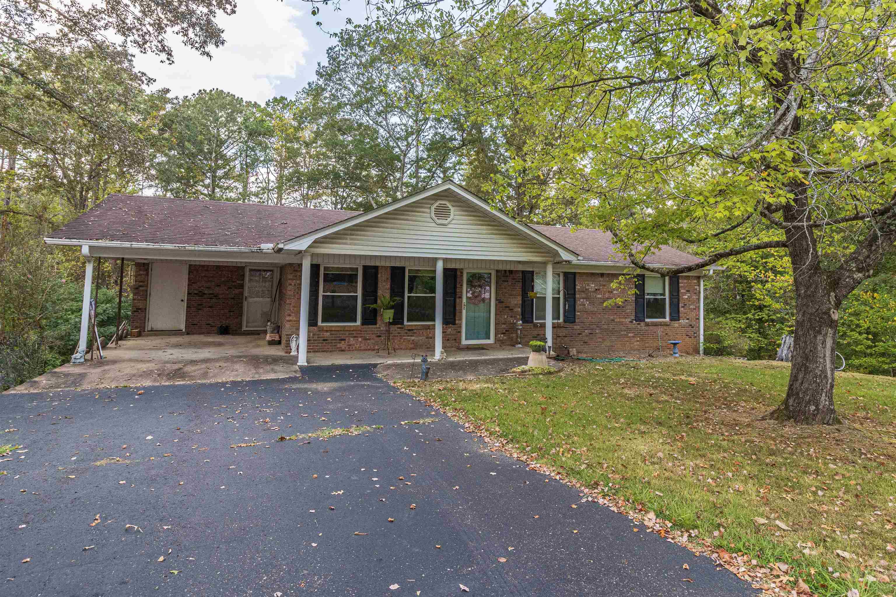 260 Mitchell Street Selmer, TN 38375 - Photo 22 of 22 a front view of a house with a garden and porch