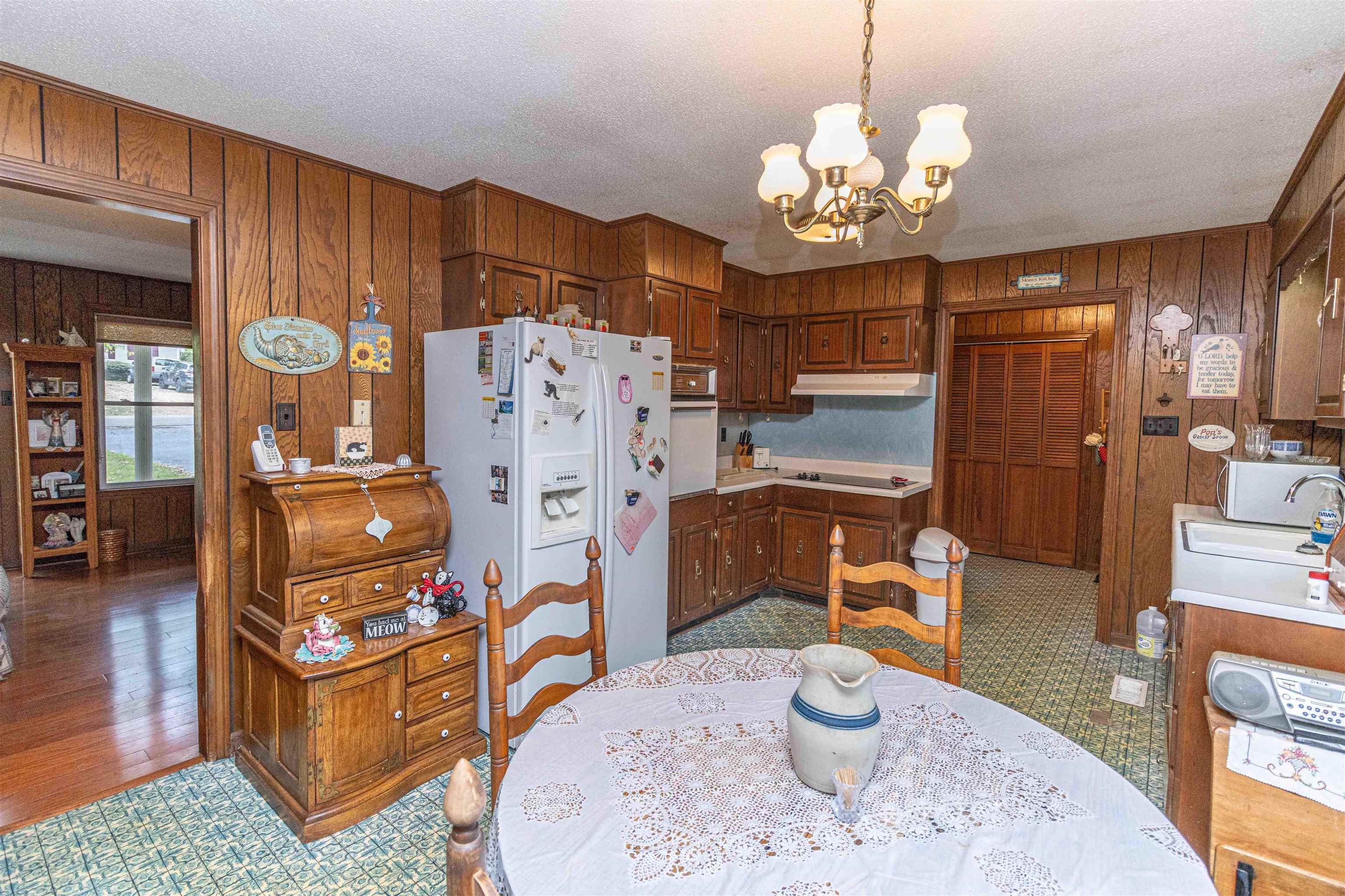 260 Mitchell Street Selmer, TN 38375 - Photo 8 of 22 a kitchen with stainless steel appliances granite countertop a refrigerator a sink dishwasher a dining table and chairs with wooden floor