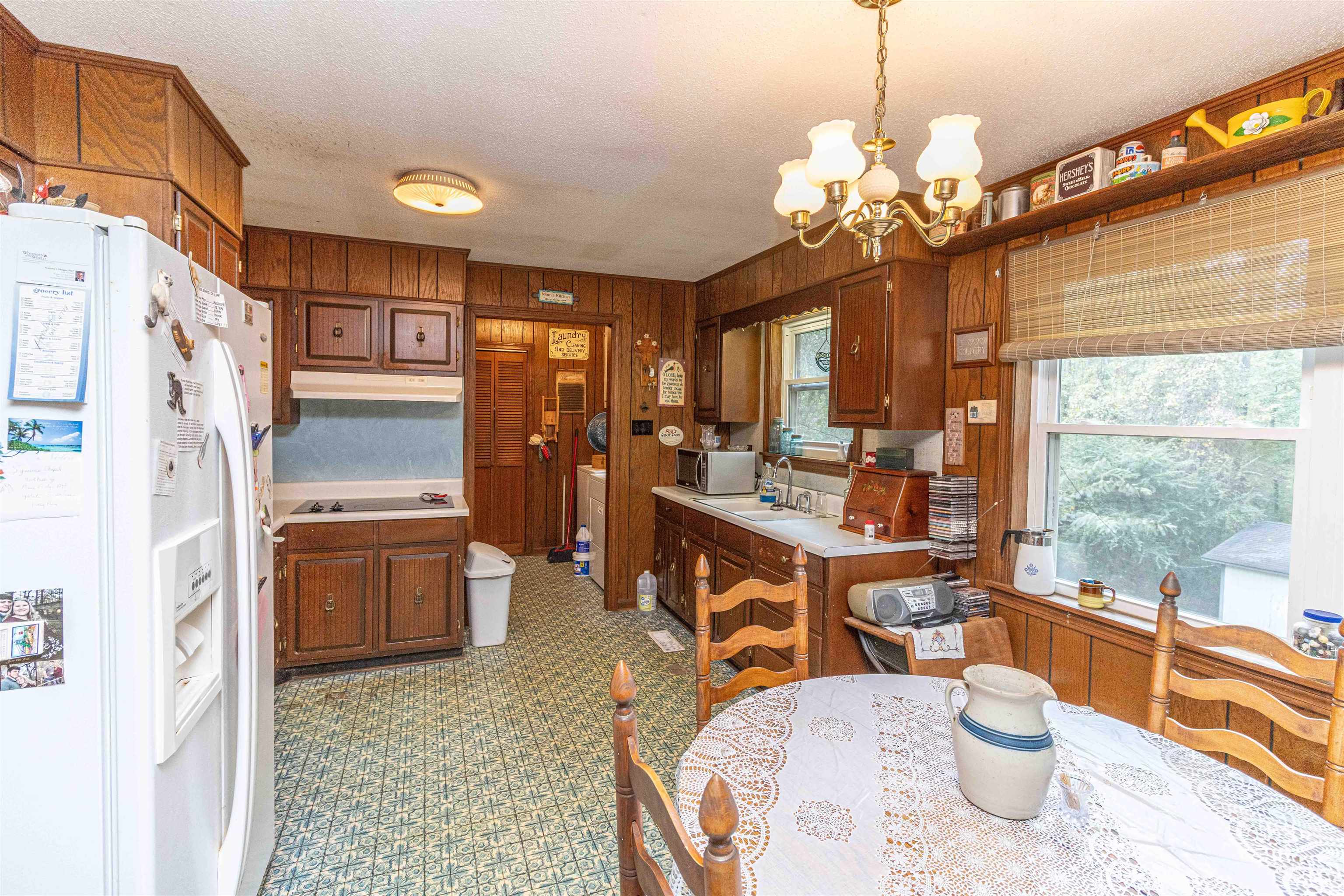 260 Mitchell Street Selmer, TN 38375 - Photo 10 of 22 a dining room with furniture a chandelier and wooden floor