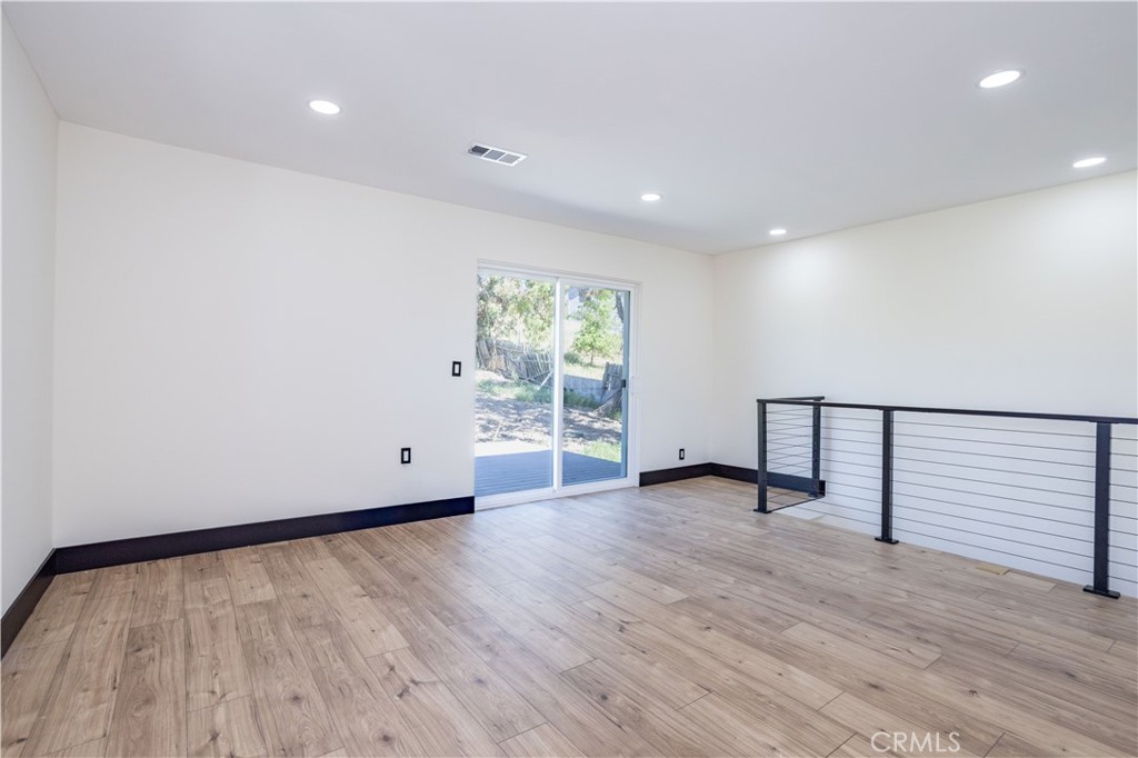 42640 Ranch Club Road Lake Hughes, CA 93532 - Photo 6 of 27 a view of an empty room with wooden floor and a window
