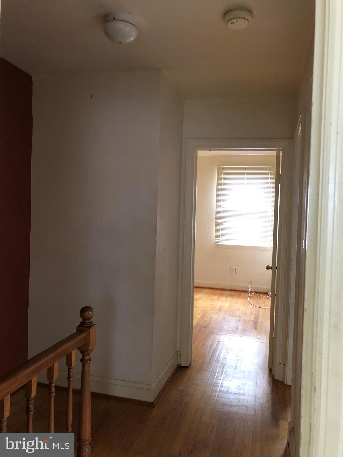 3710 Springwood Avenue Baltimore, MD 21206 - Photo 8 of 12 a view of a hallway with wooden floor and a window