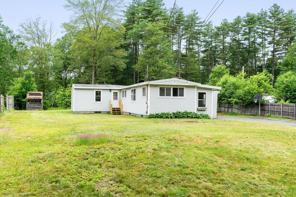 24 Horton Road Orange, MA 01364 - Photo 1 of 32 a front view of a house with a yard and trees
