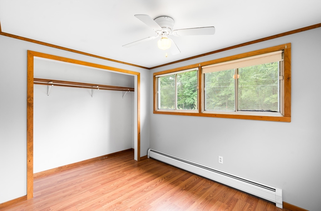 24 Horton Road Orange, MA 01364 - Photo 11 of 32 a view of an empty room with a window and wooden floor