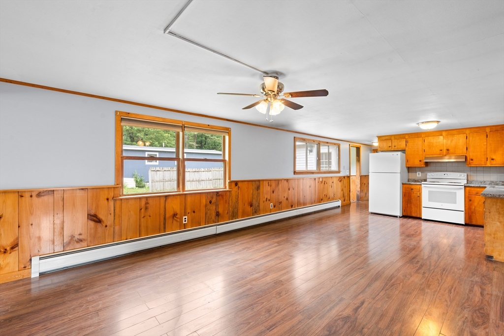 24 Horton Road Orange, MA 01364 - Photo 2 of 32 a view of an empty room with a window and wooden floor