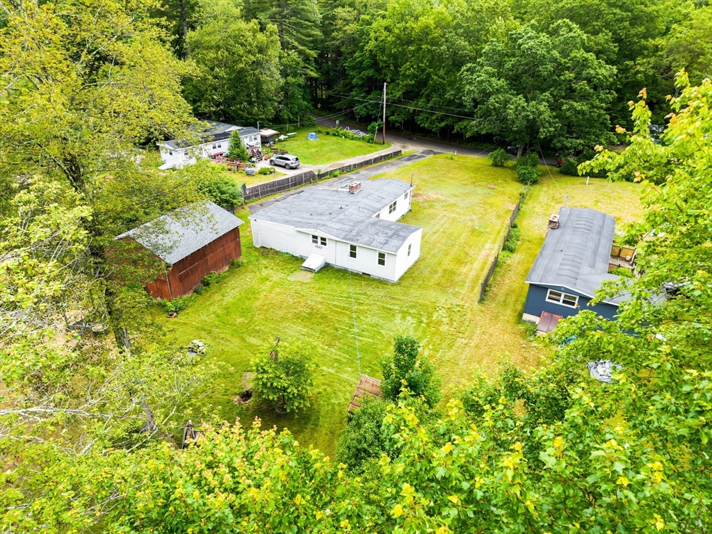 24 Horton Road Orange, MA 01364 - Photo 28 of 32 a view of a swimming pool with lawn chairs and plants