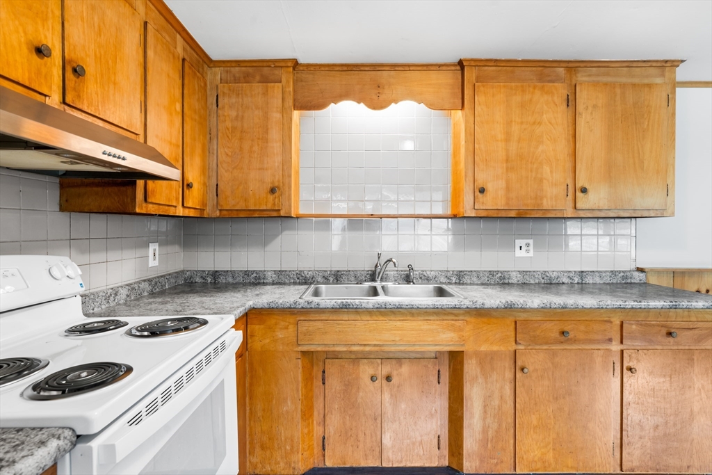24 Horton Road Orange, MA 01364 - Photo 5 of 32 a kitchen with a sink a cabinets and appliances