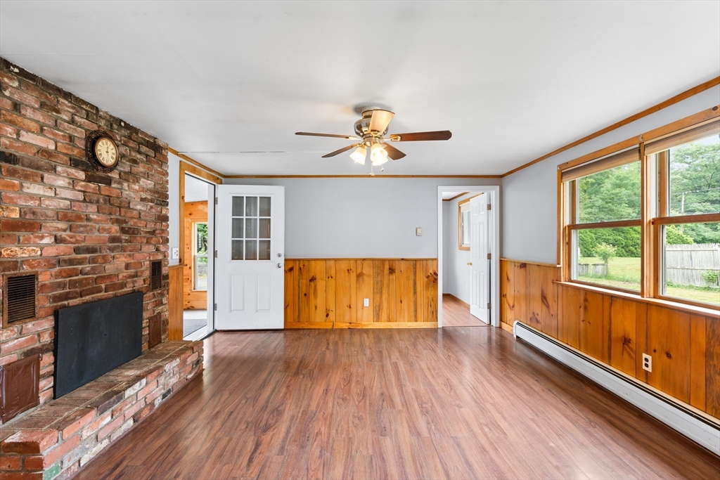 24 Horton Road Orange, MA 01364 - Photo 6 of 32 a view of empty room with a fireplace and wooden floor