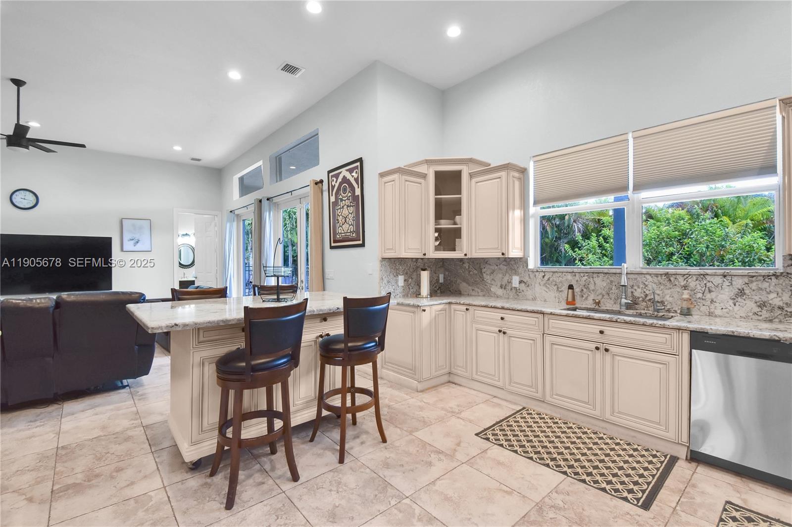 16541 Southwest 62nd Street Southwest Ranches, FL 33331 - Photo 12 of 37 a kitchen with a sink dining table and chairs