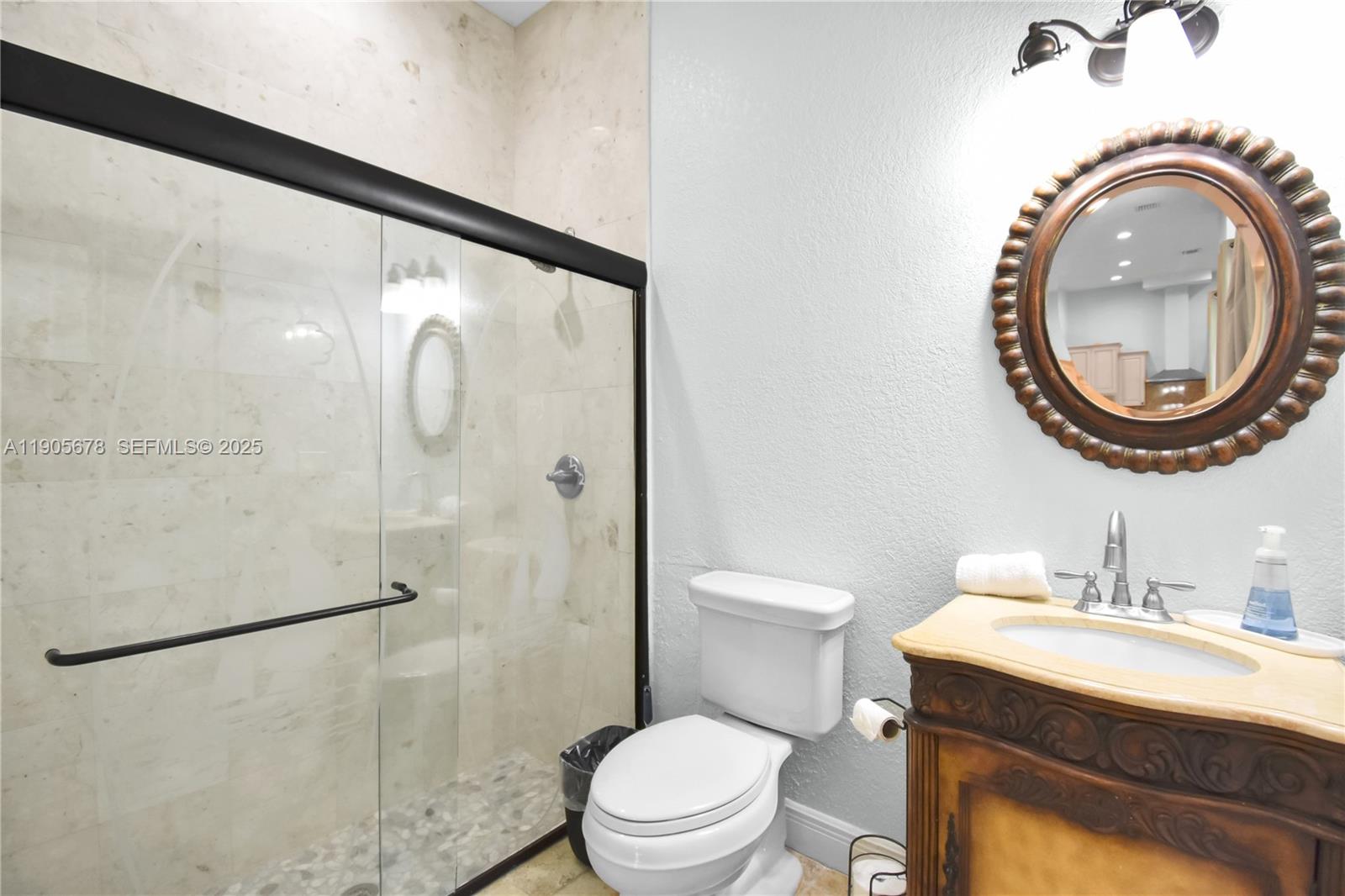 16541 Southwest 62nd Street Southwest Ranches, FL 33331 - Photo 23 of 37 a bathroom with a sink a toilet and a mirror