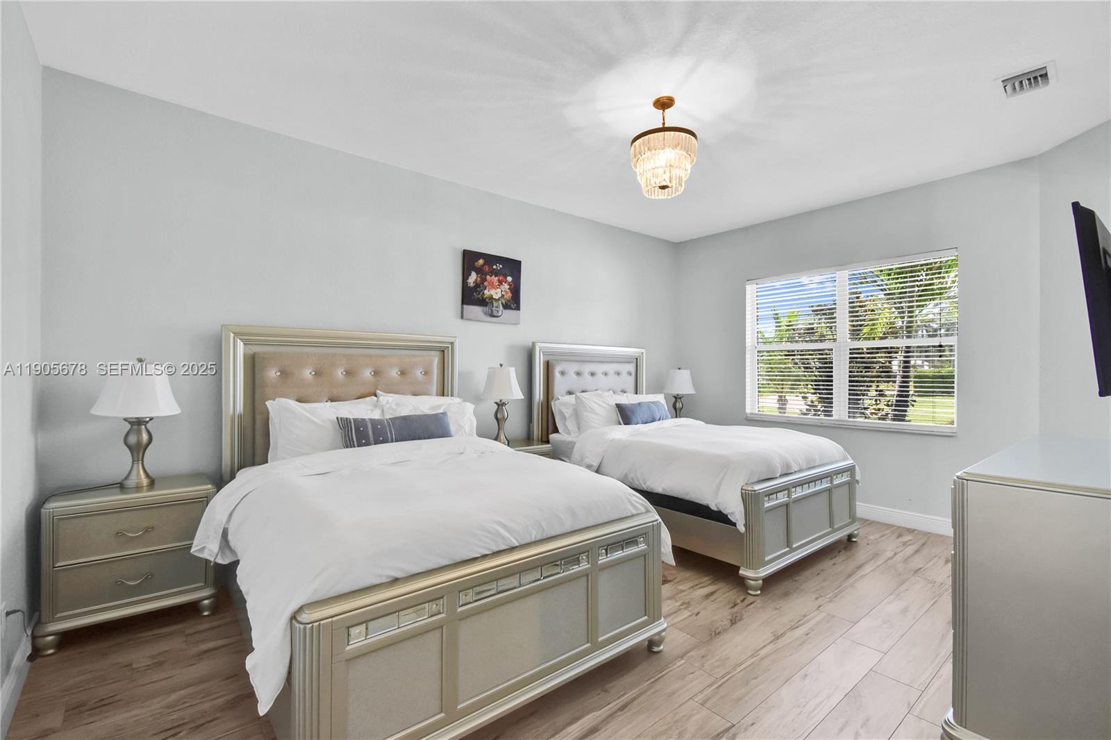 16541 Southwest 62nd Street Southwest Ranches, FL 33331 - Photo 24 of 37 a bedroom with two beds and a large window