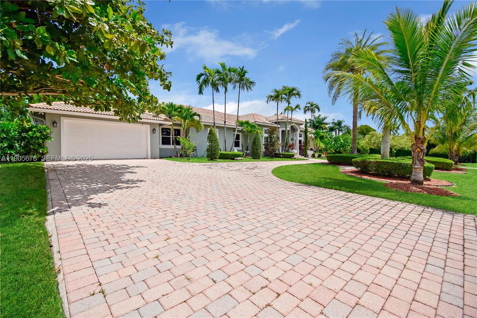 16541 Southwest 62nd Street Southwest Ranches, FL 33331 - Photo 34 of 37 a front view of a house with a yard and potted plants