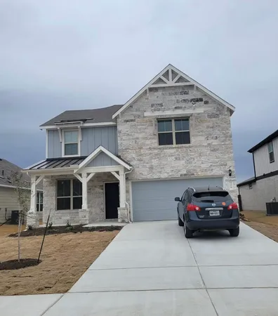 a front view of a house with parking space