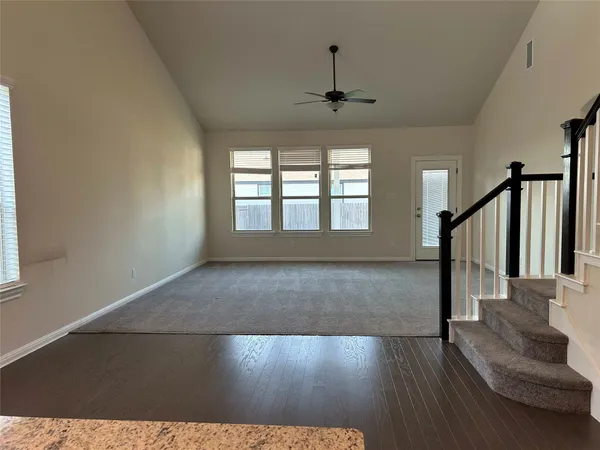 an empty room with closet and a chandelier fan
