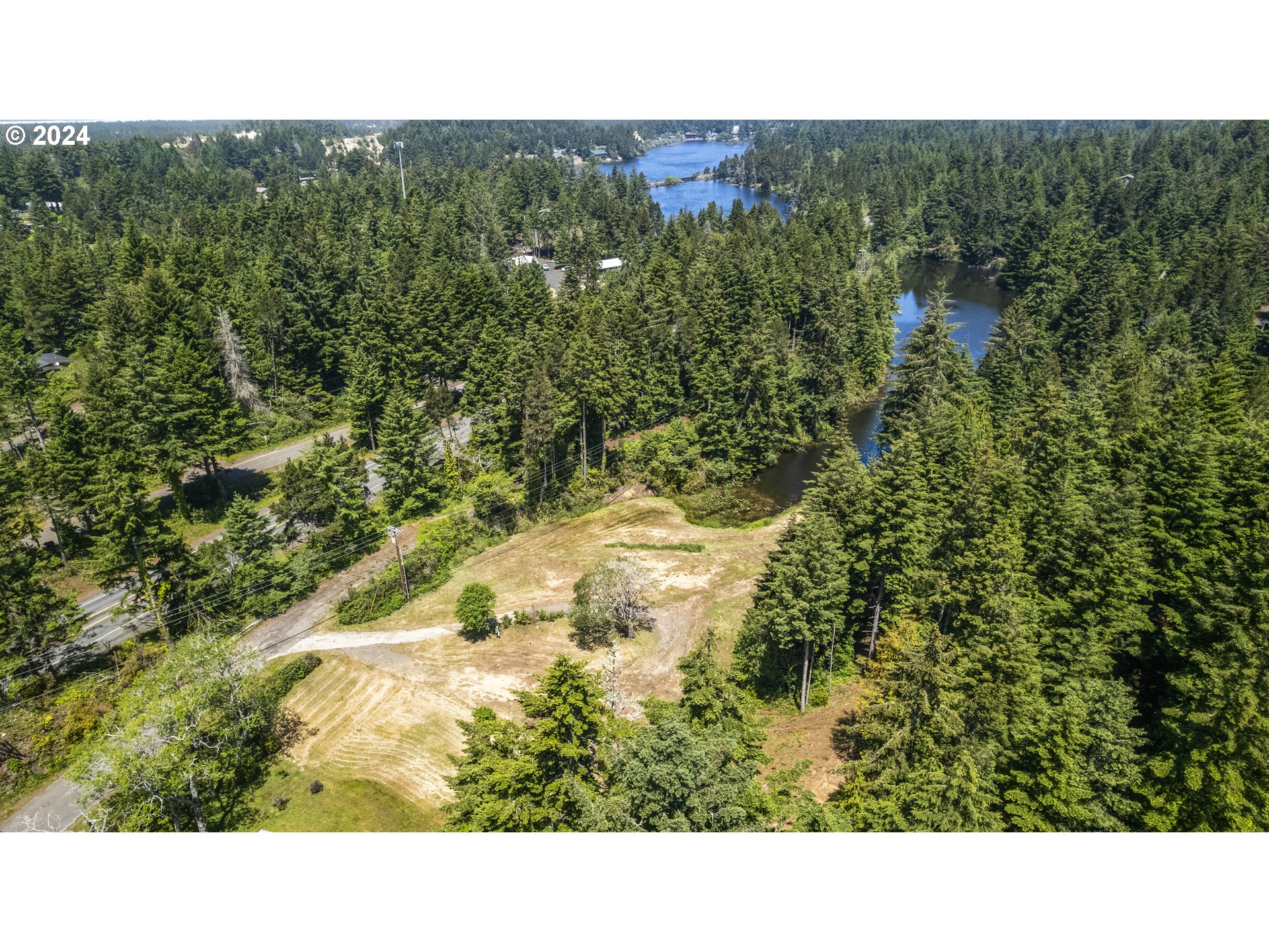 69919 Riddling Road North Bend, OR 97459 - Photo 1 of 28 a open area with a yard and mountain view
