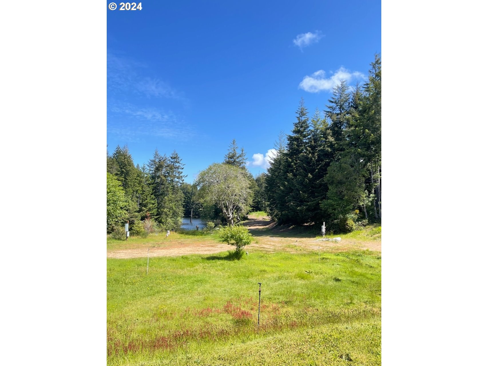 69919 Riddling Road North Bend, OR 97459 - Photo 20 of 28 a swimming pool with trees in the background