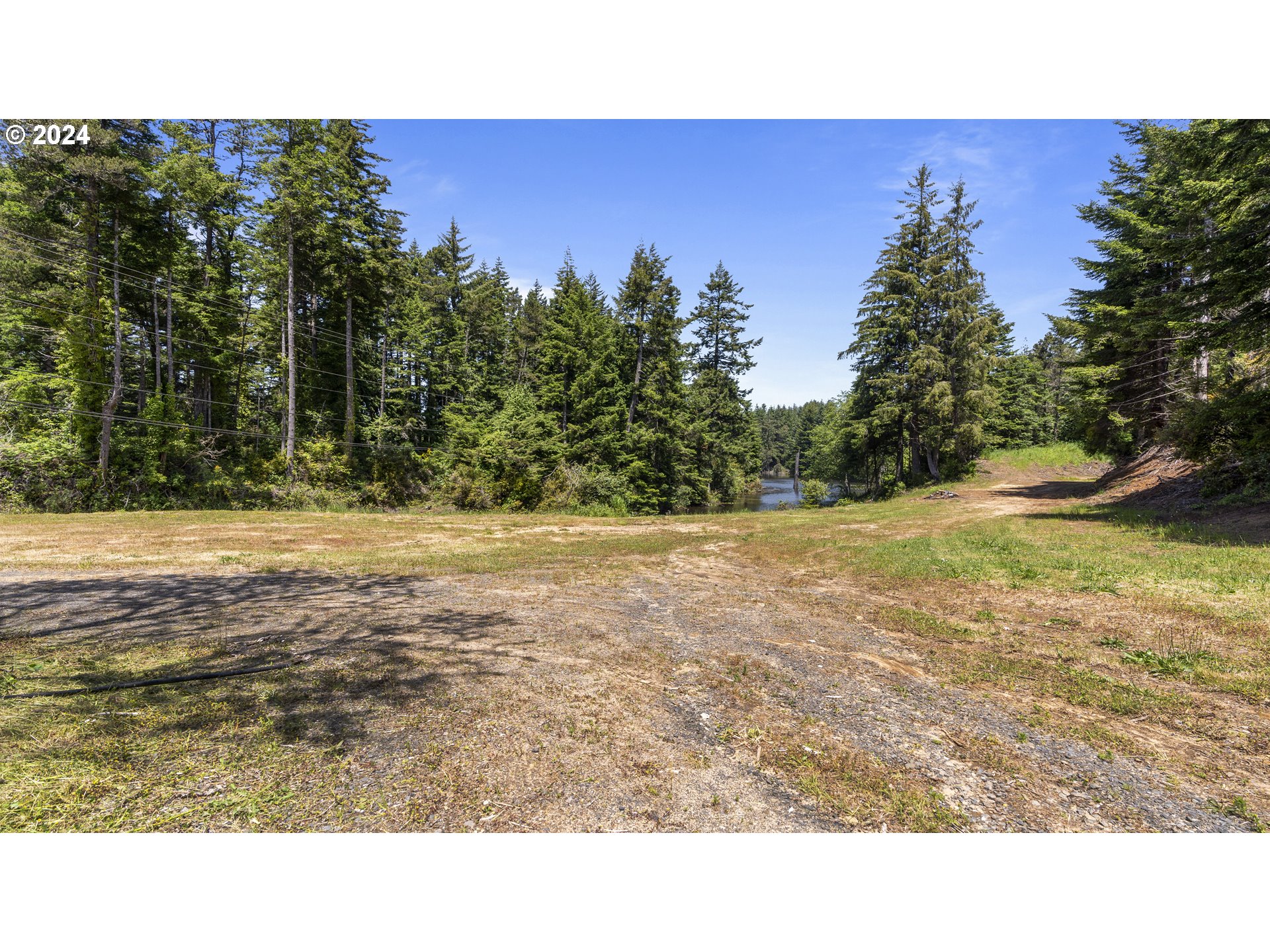 69919 Riddling Road North Bend, OR 97459 - Photo 6 of 28 a open area with trees in the background