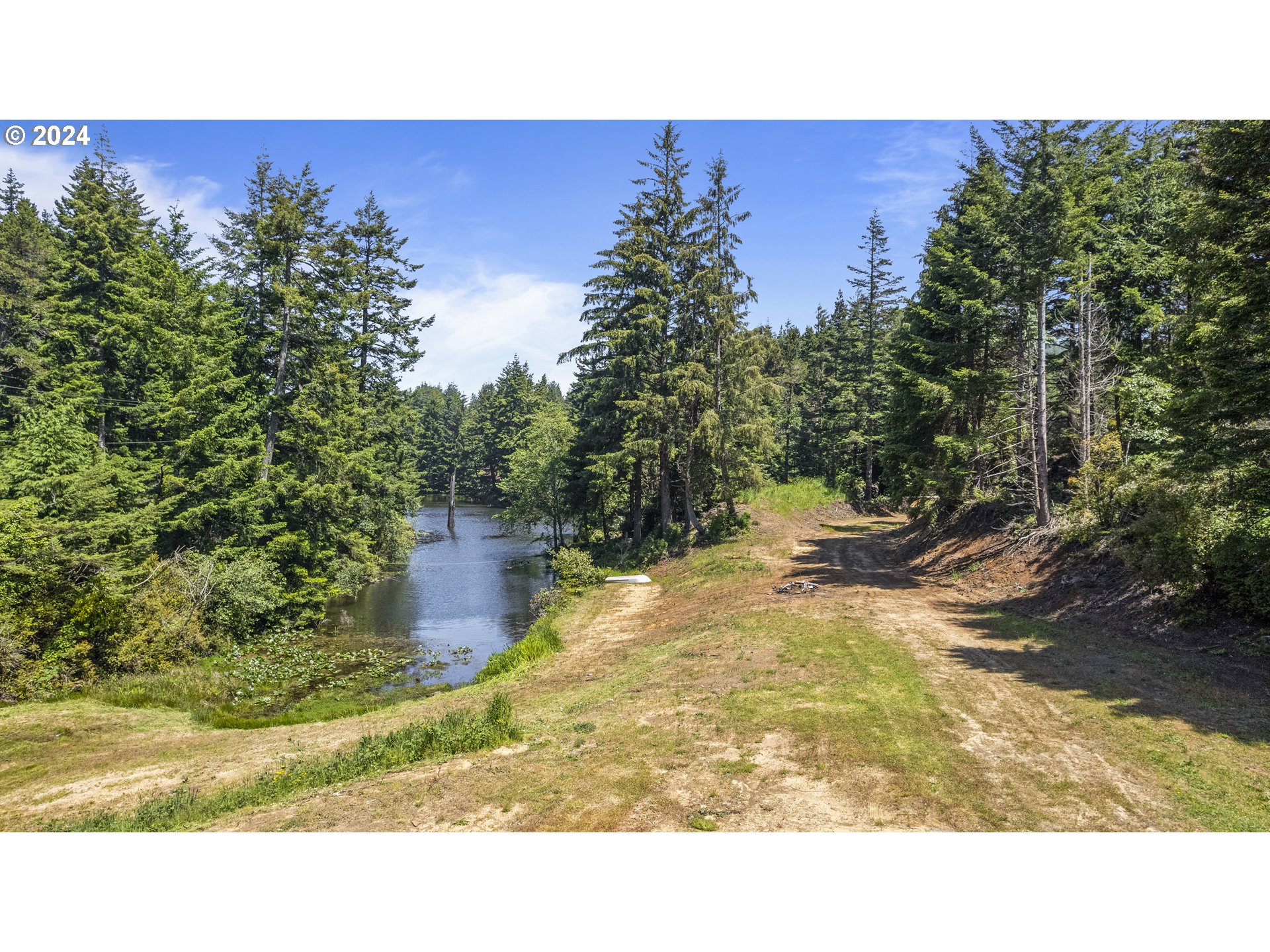 69919 Riddling Road North Bend, OR 97459 - Photo 10 of 28 a outdoor living space with trees in the background