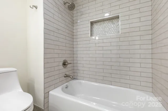 a bathroom with a toilet and bathtub