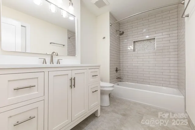 a bathroom with a shower a sink and a mirror