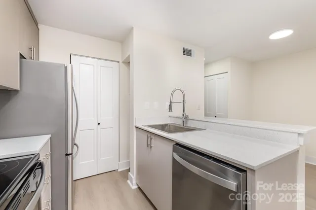 a view of a sink storage and utility room with washer and dryer