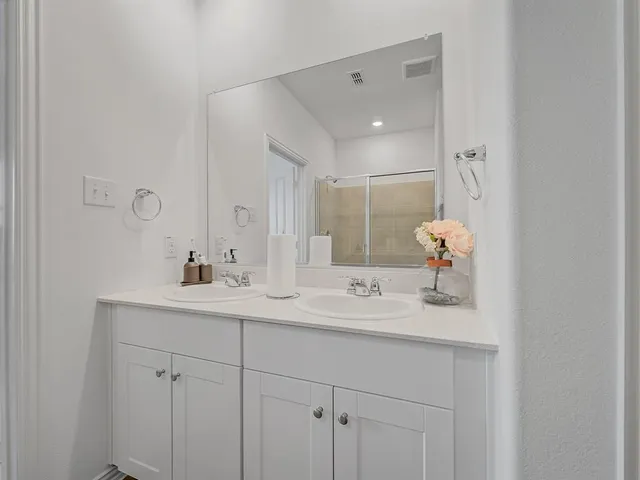 a bathroom with a shower and a sink