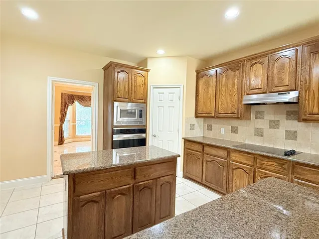 a kitchen with stainless steel appliances granite countertop a sink and cabinets