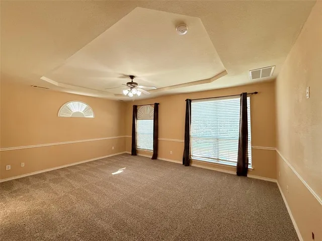 a large bathroom with a granite countertop double vanity sink a mirror and a bathtub