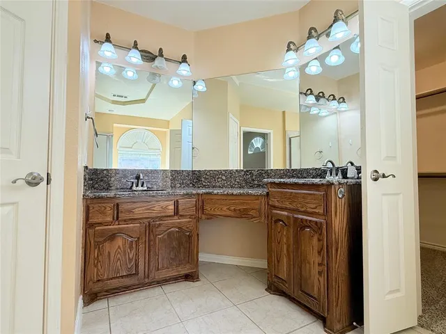 a bathroom with a tub a mirror and a shower