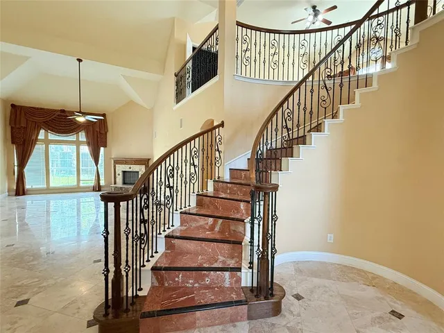 a view of staircase with wooden floor and a chandelier