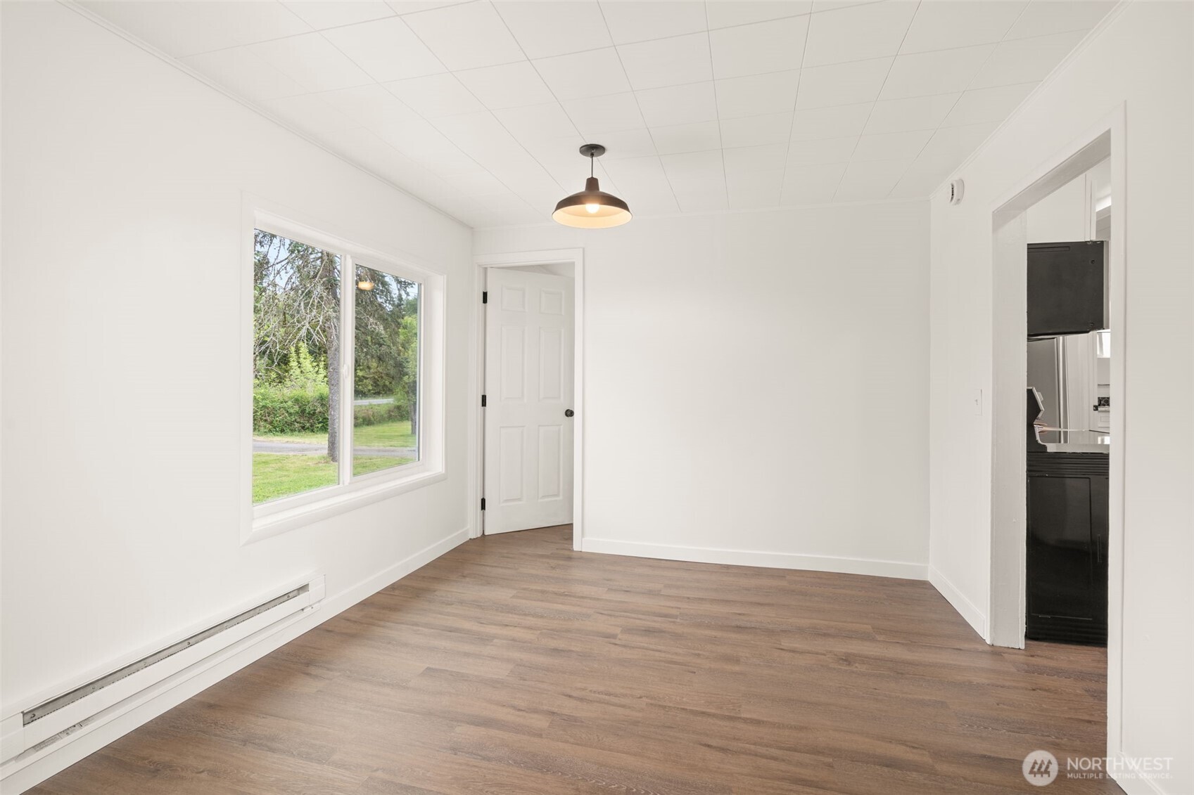 2222 Cooks Hill Road Centralia, WA 98531 - Photo 15 of 36 an empty room with wooden floor cabinet and windows