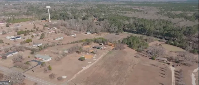 a view of a dry yard with wooden fence