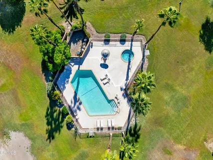 an aerial view of a house with a swimming pool