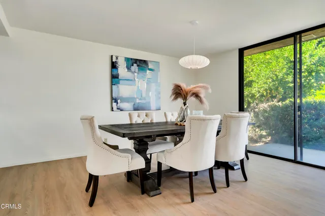 a view of a dining room with furniture window and outside view
