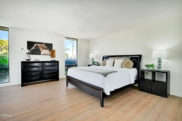 a bedroom with a bed and a tv on table