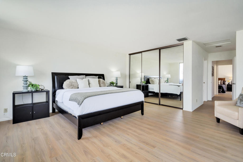 72460 Rodeo Way Rancho Mirage, CA 92270 - Photo 13 of 40 a spacious bedroom with a bed and wooden floor