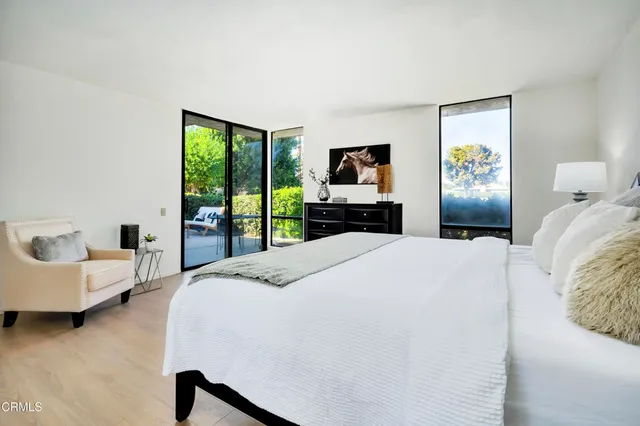 a bedroom with a bed and a large window