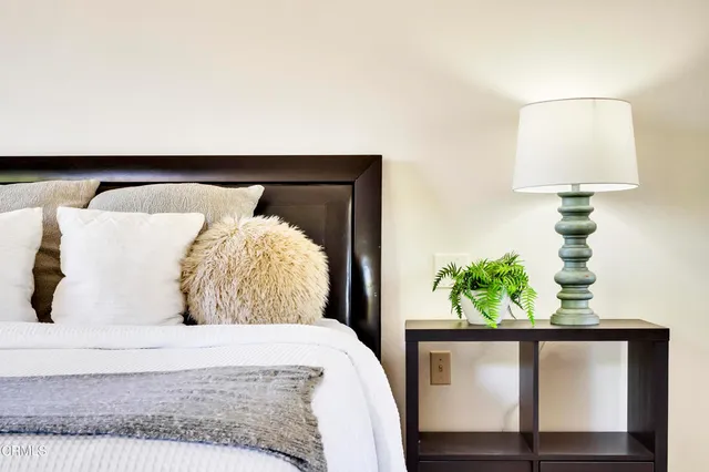 a bedroom with a bed and a lamp on table