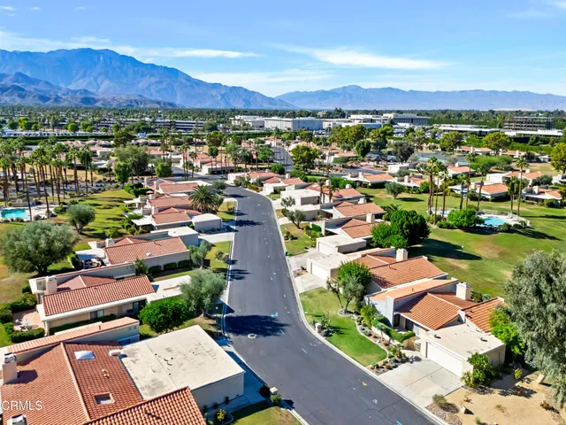 an aerial view of residential houses with outdoor space and street view