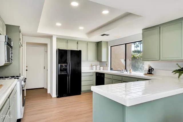 a kitchen with a sink stove and refrigerator